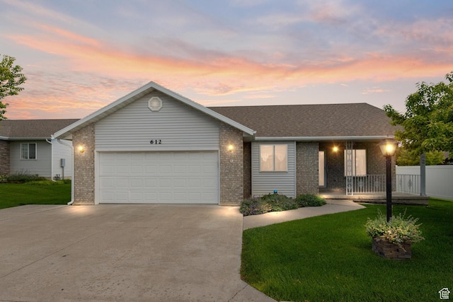 view of front of house with a garage and a yard