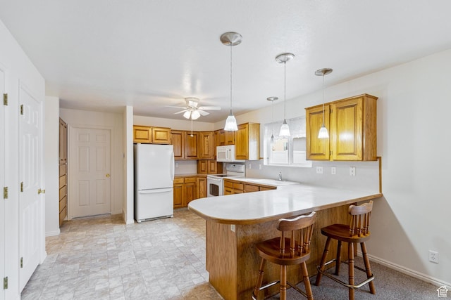 612 E 1280 N, Logan, UT 84341 - kitchen featuring sink, white appliances, a breakfast bar, hanging light fixtures, and kitchen peninsula