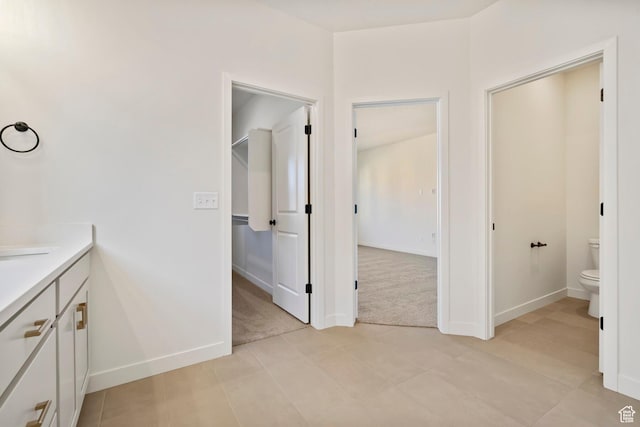 10033 N Torreya Dr Unit 737, Highland, UT 84003 - bathroom featuring toilet, baseboards, and vanity