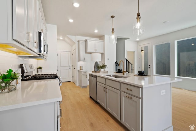 10033 N Torreya Dr Unit 737, Highland, UT 84003 - kitchen featuring a sink, stainless steel appliances, light wood finished floors, light countertops, and recessed lighting