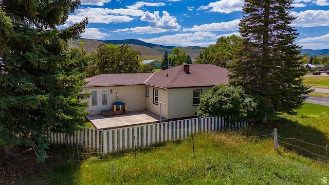 186 S 100 E St E, Laketown, UT 84038 - back of house with a lawn, a patio, a fenced backyard, french doors, and a mountain view