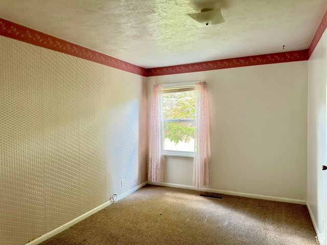 186 S 100 E St E, Laketown, UT 84038 - carpeted spare room with wallpapered walls, baseboards, visible vents, and a textured ceiling