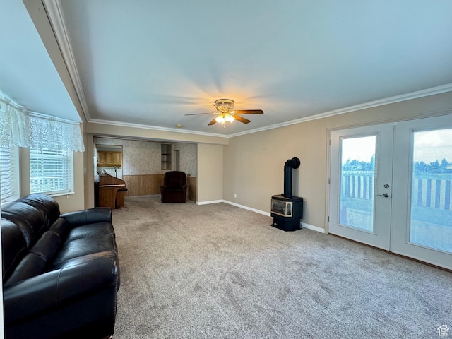 186 S 100 E St E, Laketown, UT 84038 - carpeted living area with french doors, ornamental molding, a ceiling fan, a wood stove, and baseboards
