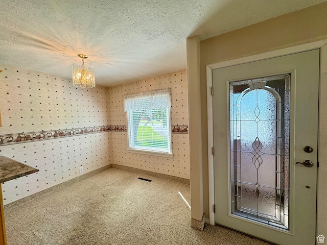 186 S 100 E St E, Laketown, UT 84038 - foyer entrance featuring carpet floors, visible vents, a textured ceiling, and wallpapered walls