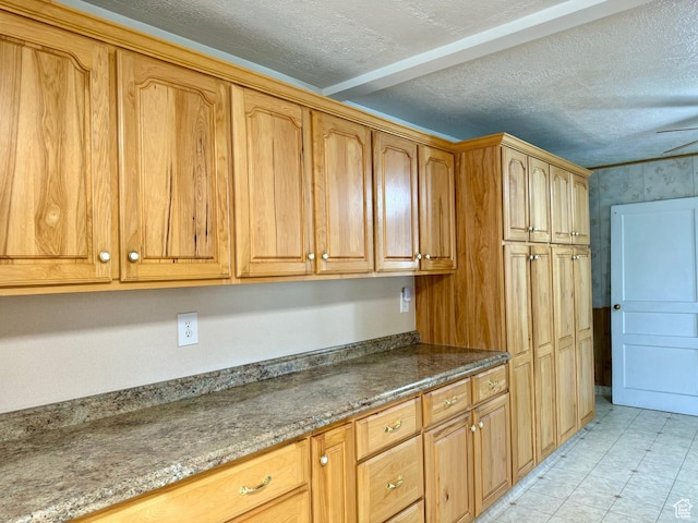 186 S 100 E St E, Laketown, UT 84038 - kitchen featuring a textured ceiling and dark stone countertops