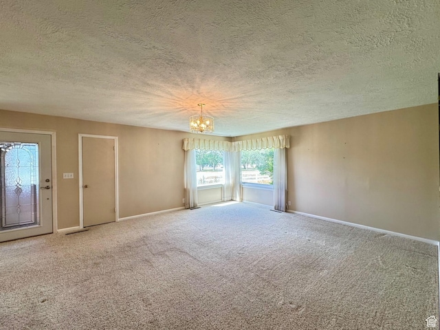 186 S 100 E St E, Laketown, UT 84038 - unfurnished room featuring carpet flooring, a textured ceiling, baseboards, and an inviting chandelier