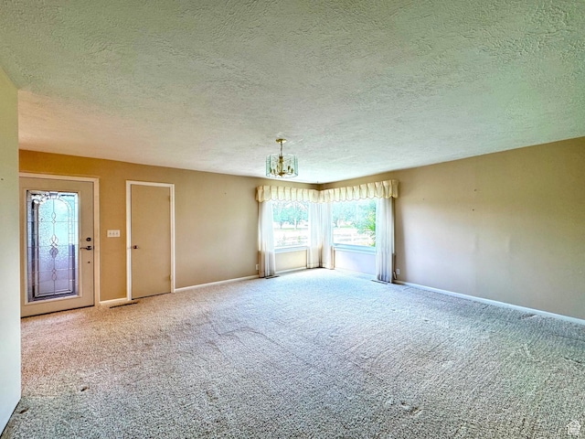 186 S 100 E St E, Laketown, UT 84038 - carpeted spare room featuring a textured ceiling, a chandelier, and baseboards