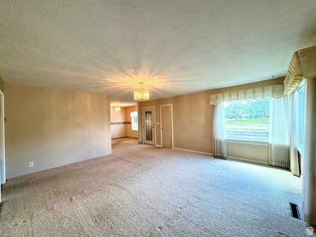 186 S 100 E St E, Laketown, UT 84038 - interior space featuring carpet floors, a textured ceiling, and an inviting chandelier