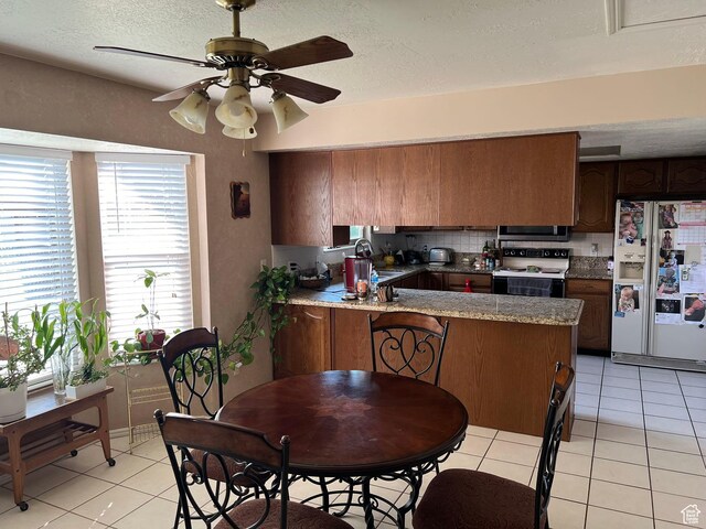 3383 W 6880 S, West Jordan, UT 84084 - kitchen with a sink, light tile patterned floors, white appliances, a peninsula, and ceiling fan