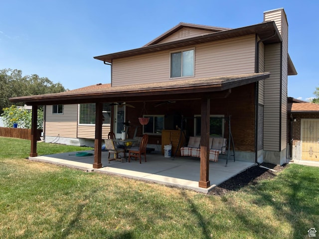 3383 W 6880 S, West Jordan, UT 84084 - rear view of house with a chimney, fence, ceiling fan, a patio area, and a lawn