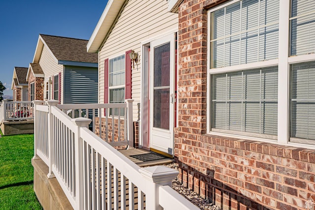 80 E 300 N Unit 3, Preston, ID 83263 - view of exterior entry with a wooden deck, brick siding, and a shingled roof