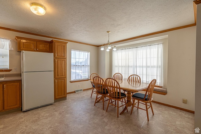 80 E 300 N Unit 3, Preston, ID 83263 - dining space with an inviting chandelier, light floors, visible vents, baseboards, and ornamental molding