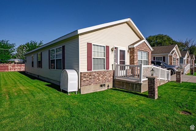 80 E 300 N Unit 3, Preston, ID 83263 - exterior space featuring a front lawn, brick siding, fence, and a deck