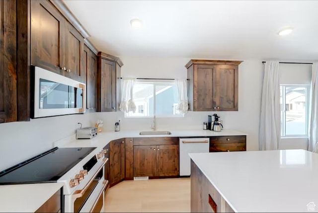 2216 S Beachcomber Ln, Garden City, UT 84028 - kitchen with a sink, white appliances, and light countertops