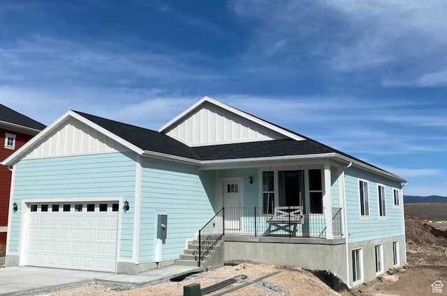 2216 S Beachcomber Ln, Garden City, UT 84028 - view of front facade featuring an attached garage, covered porch, board and batten siding, and driveway