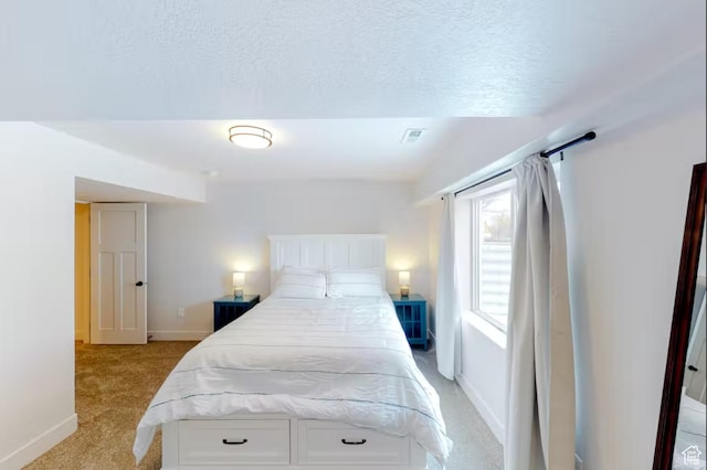 2216 S Beachcomber Ln, Garden City, UT 84028 - bedroom with a textured ceiling, visible vents, baseboards, and light carpet