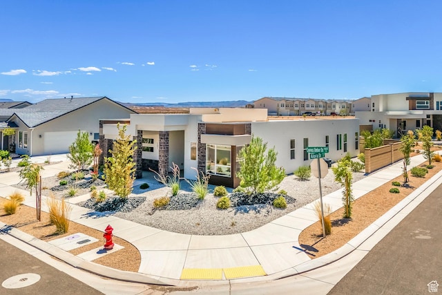 581 W Cypress Umber Dr Unit 34, St George, UT 84790 - contemporary home with stucco siding, a residential view, driveway, an attached garage, and stone siding