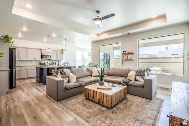 581 W Cypress Umber Dr Unit 34, St George, UT 84790 - living room with a tray ceiling, light wood finished floors, a ceiling fan, recessed lighting, and baseboards