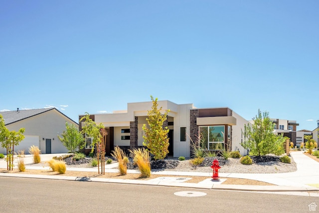 581 W Cypress Umber Dr Unit 34, St George, UT 84790 - contemporary house featuring stucco siding, stone siding, and an attached garage