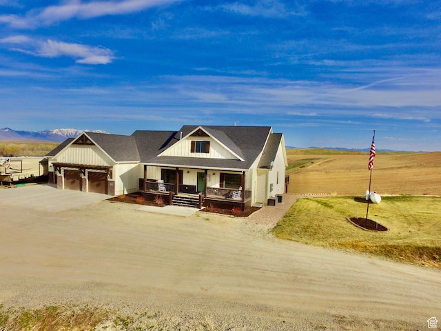 1579 N 2200 E, Preston, ID 83263 - modern farmhouse featuring a mountain view, dirt driveway, board and batten siding, an attached garage, and covered porch