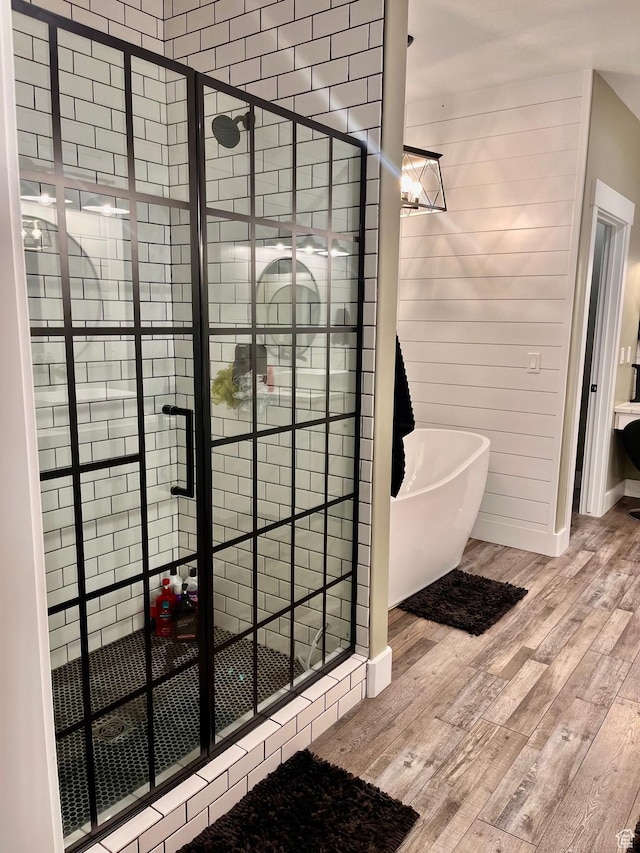 1579 N 2200 E, Preston, ID 83263 - full bathroom featuring a shower stall, a freestanding bath, and wood finished floors