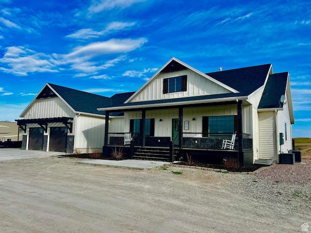 1579 N 2200 E, Preston, ID 83263 - view of front of house featuring a garage, a porch, board and batten siding, and dirt driveway