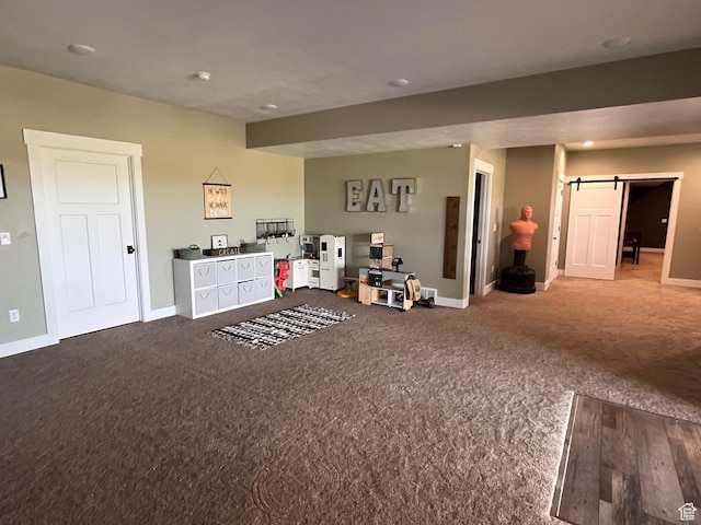 1579 N 2200 E, Preston, ID 83263 - recreation room with a barn door, carpet flooring, and baseboards