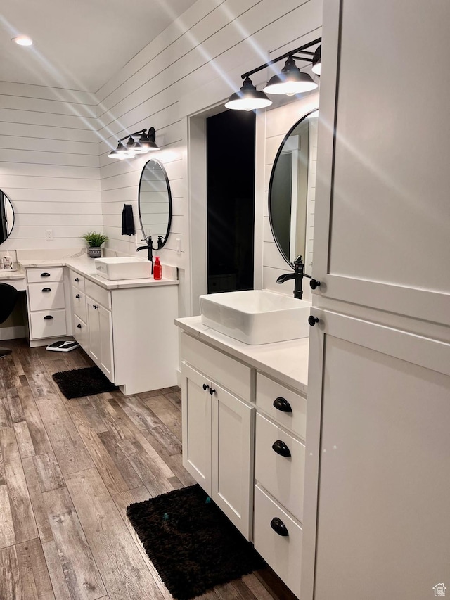 1579 N 2200 E, Preston, ID 83263 - full bath featuring two vanities, wood walls, a sink, and hardwood / wood-style flooring