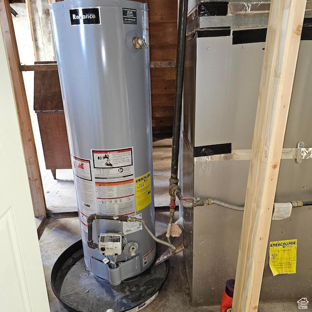 utility room featuring water heater and heating unit