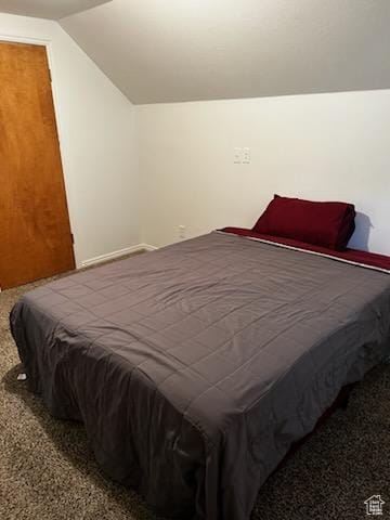 bedroom featuring lofted ceiling and carpet floors