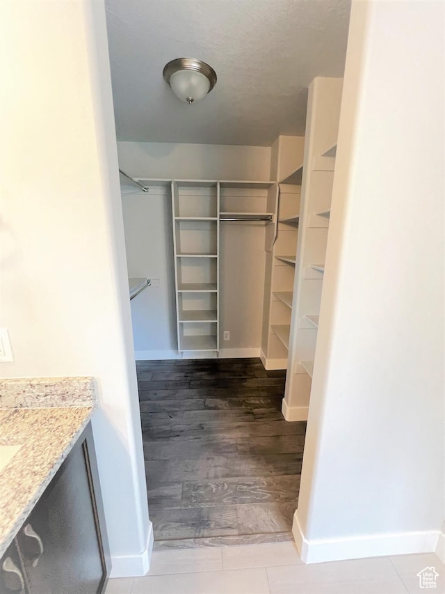 walk in closet featuring wood finished floors