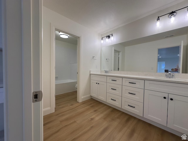 16 W 650 N Unit 1, Salem, UT 84653 - bathroom featuring wood finished floors, double vanity, baseboards, and a tub to relax in