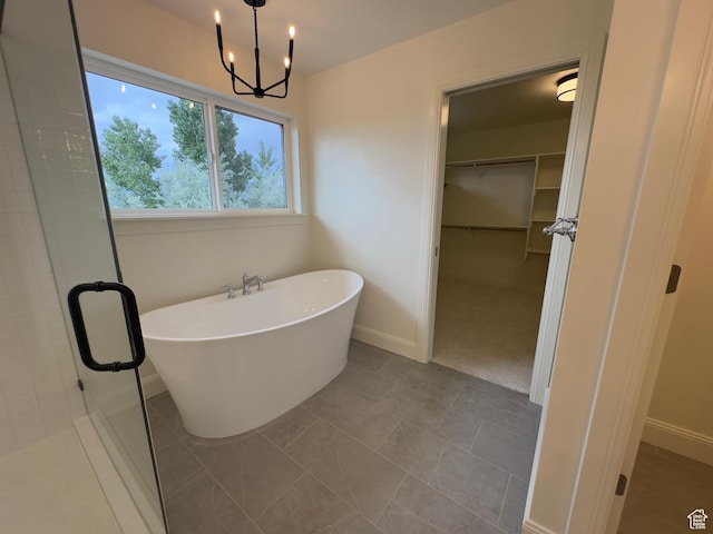 16 W 650 N Unit 1, Salem, UT 84653 - bathroom featuring a spacious closet, a soaking tub, baseboards, and a stall shower
