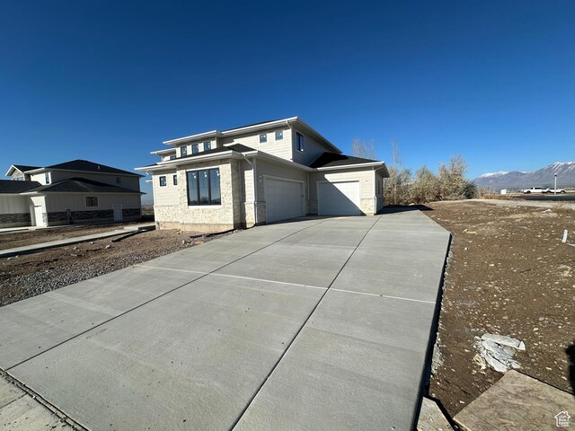 16 W 650 N Unit 1, Salem, UT 84653 - view of side of home featuring concrete driveway, a mountain view, and an attached garage