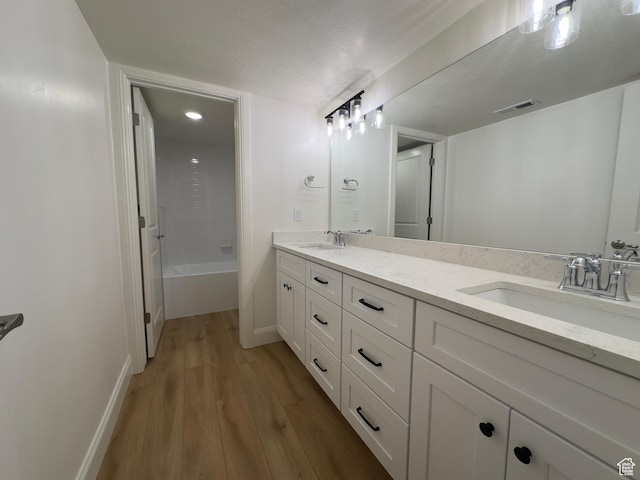16 W 650 N Unit 1, Salem, UT 84653 - full bathroom featuring wood finished floors, double vanity, a bath, and baseboards