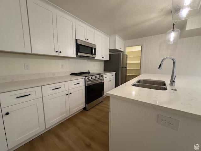 16 W 650 N Unit 1, Salem, UT 84653 - kitchen with stainless steel appliances, a sink, white cabinetry, wood finished floors, and decorative light fixtures