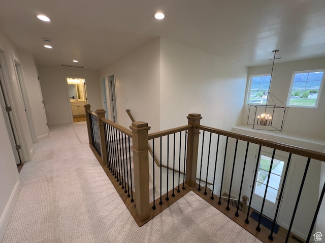 16 W 650 N Unit 1, Salem, UT 84653 - hallway featuring an upstairs landing, a chandelier, recessed lighting, light carpet, and baseboards