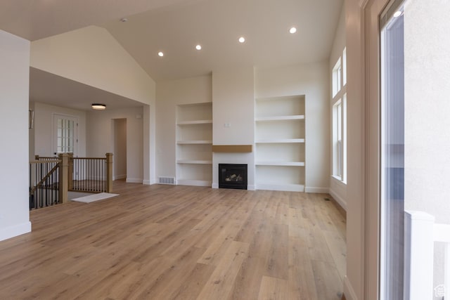 52 W 650 N Unit 3, Salem, UT 84653 - unfurnished living room featuring built in shelves, light wood finished floors, baseboards, a fireplace, and recessed lighting