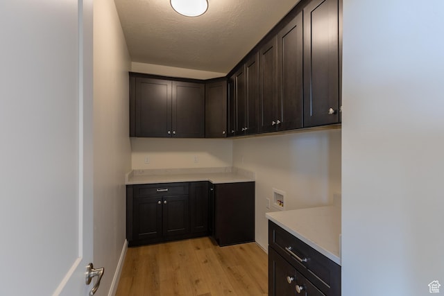 52 W 650 N Unit 3, Salem, UT 84653 - laundry area with cabinet space, light wood-style flooring, hookup for a washing machine, a textured ceiling, and baseboards