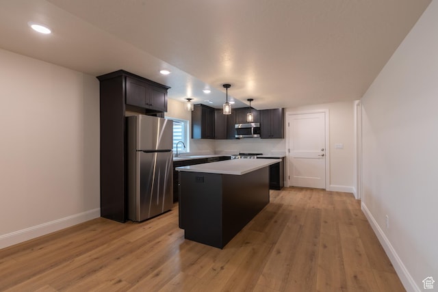52 W 650 N Unit 3, Salem, UT 84653 - kitchen featuring appliances with stainless steel finishes, a center island, light countertops, light wood-style flooring, and baseboards