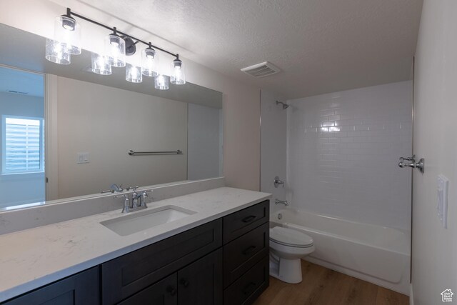 52 W 650 N Unit 3, Salem, UT 84653 - bathroom featuring wood finished floors, vanity, a textured ceiling, toilet, and bathtub / shower combination