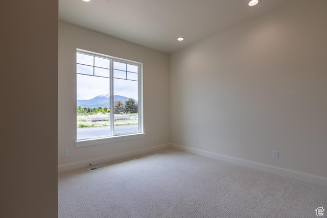 52 W 650 N Unit 3, Salem, UT 84653 - empty room featuring a mountain view, recessed lighting, light colored carpet, and baseboards