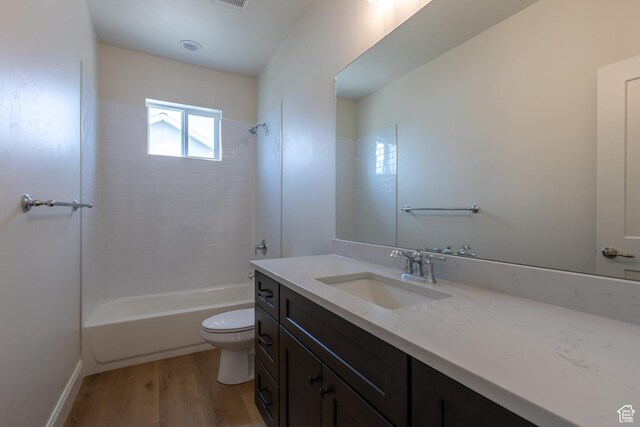 52 W 650 N Unit 3, Salem, UT 84653 - bathroom featuring toilet, vanity, wood finished floors, and washtub / shower combination