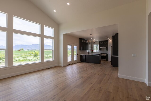 52 W 650 N Unit 3, Salem, UT 84653 - unfurnished living room featuring a chandelier, a sink, light wood-style floors, baseboards, and recessed lighting