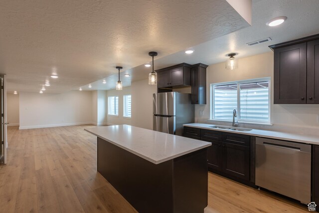 52 W 650 N Unit 3, Salem, UT 84653 - kitchen featuring stainless steel appliances, a sink, a textured ceiling, light countertops, and recessed lighting