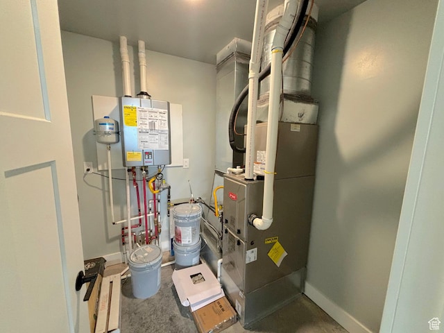 utility room featuring tankless water heater and heating unit