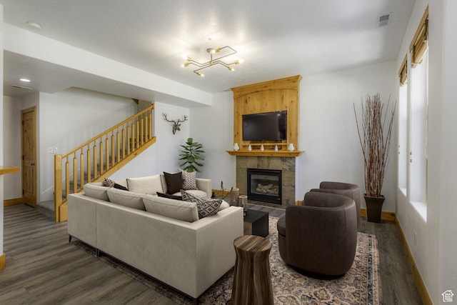 1746 W Redstone Ave # G, Park City, UT 84098 - living room featuring an inviting chandelier, dark hardwood / wood-style floors, and a stone fireplace