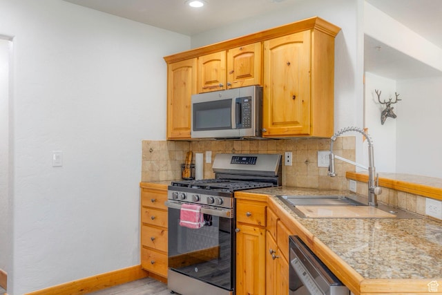 1746 W Redstone Ave # G, Park City, UT 84098 - kitchen featuring light wood-type flooring, sink, appliances with stainless steel finishes, and tasteful backsplash