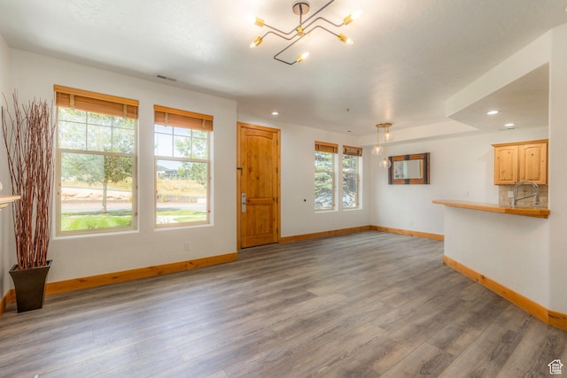 1746 W Redstone Ave # G, Park City, UT 84098 - unfurnished living room featuring sink, a healthy amount of sunlight, and wood-type flooring