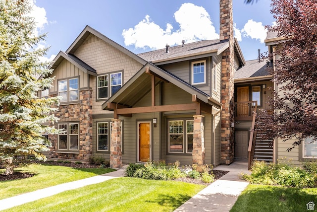 craftsman-style house with a front lawn